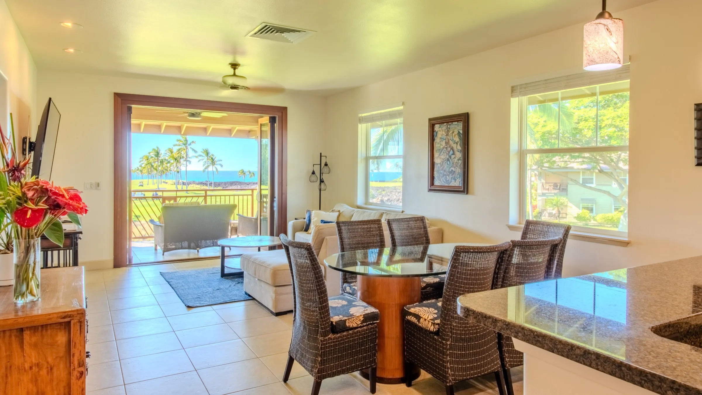 Living and dining area with the covered lanai and the Pacific beyond