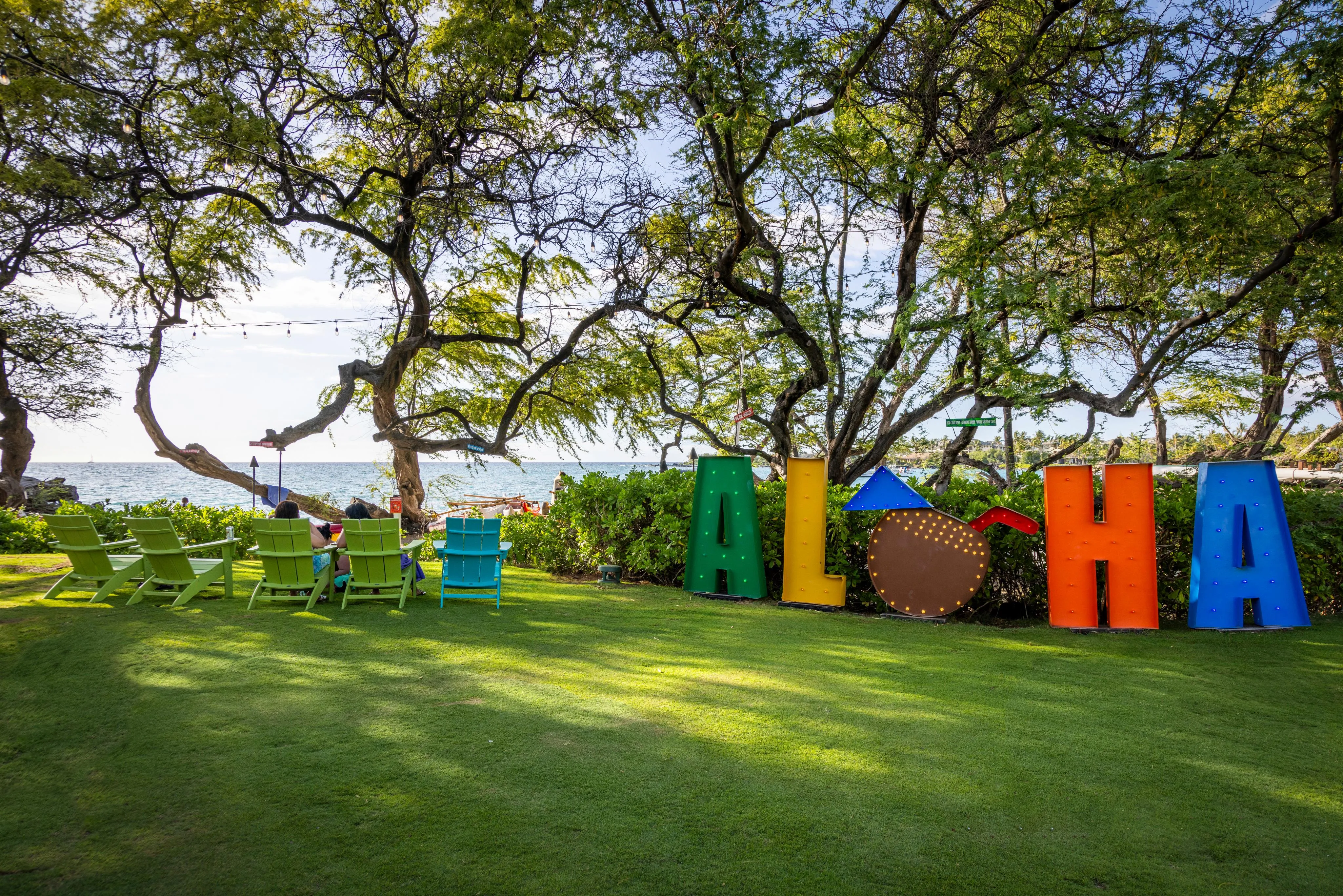 Colorful ALOHA letters on the lawn beneath the club's shade trees