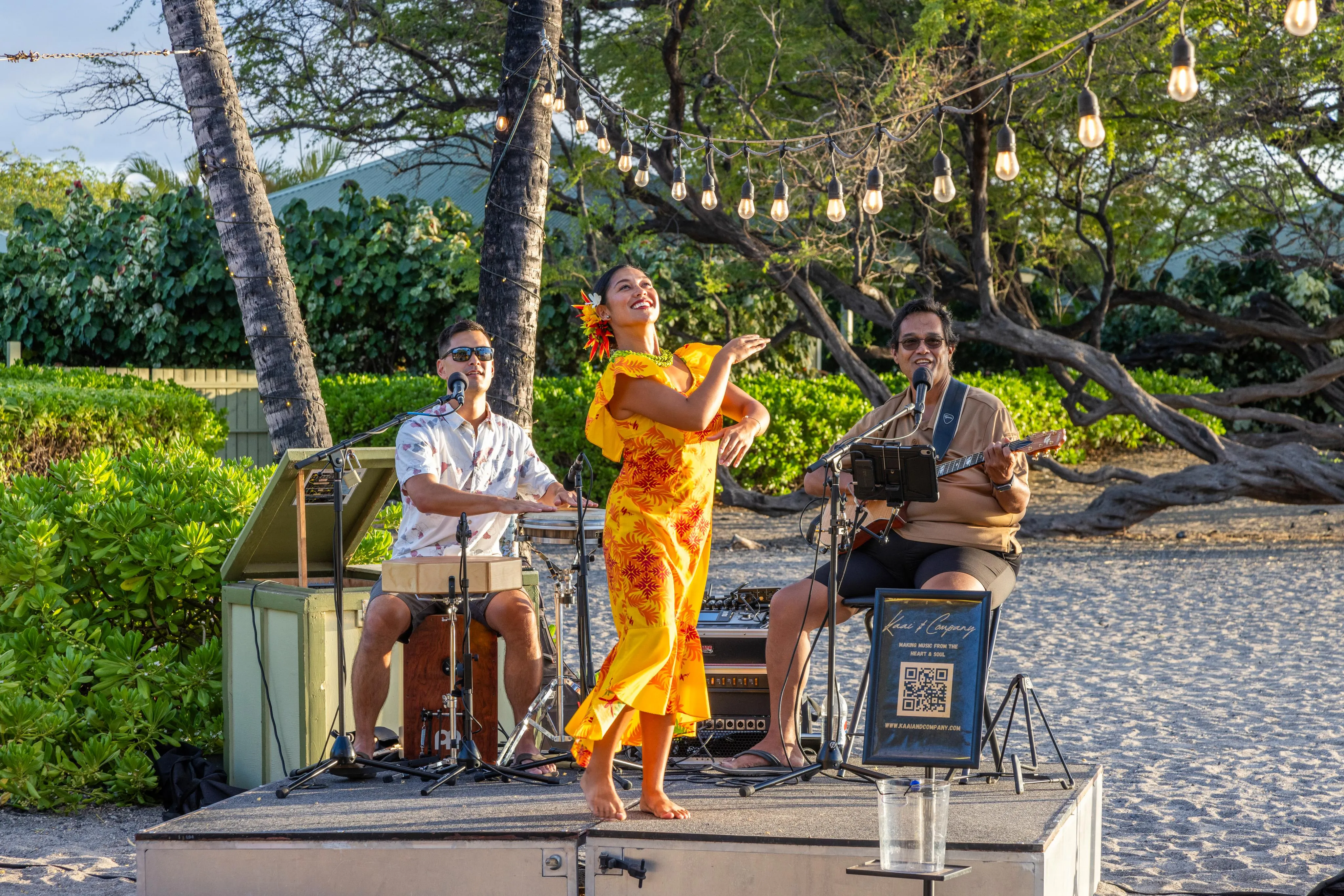 Live Hawaiian musicians performing on the beachfront stage