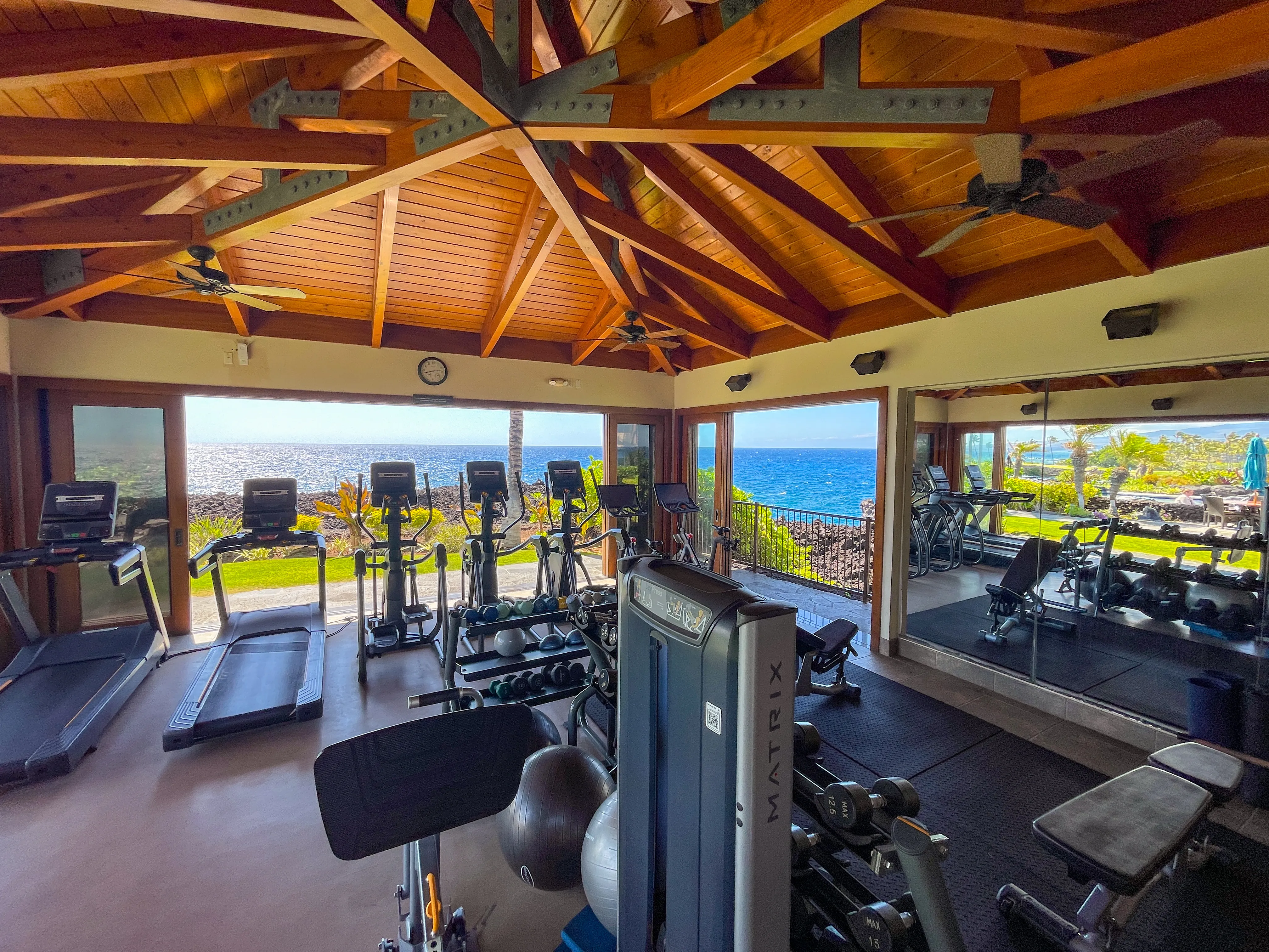 The oceanfront fitness center at the Hali'i Kai Ocean Club with equipment facing the water